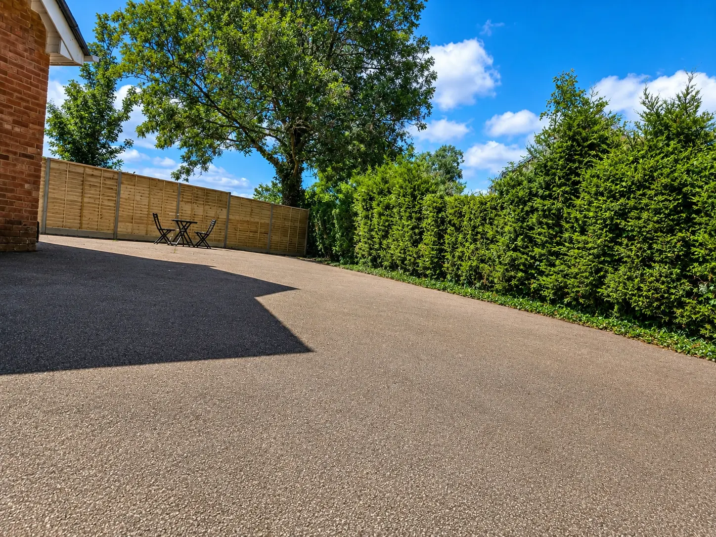 Side garden and driveway with bistro seating